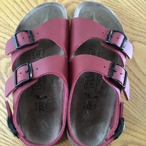 Double-strap red Birkenstocks with heel strap
